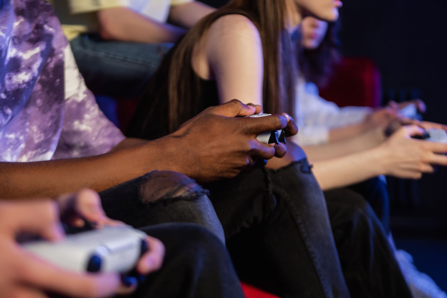 Teens playing video games with controllers, focused and engaged. — Features and services that make the online sports betting