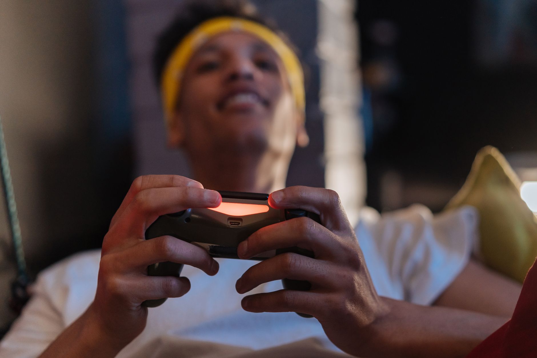 A relaxed gaming session with a close-up view of a man holding a game controller indoors. — Plan for the Future with Koitoto